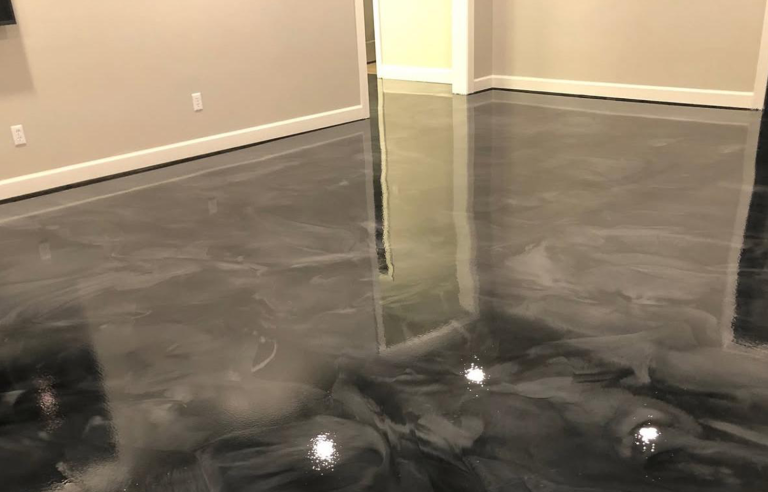 Before-and-after of garage floor: plain concrete vs. dark gray flake epoxy coating with gloss finish
