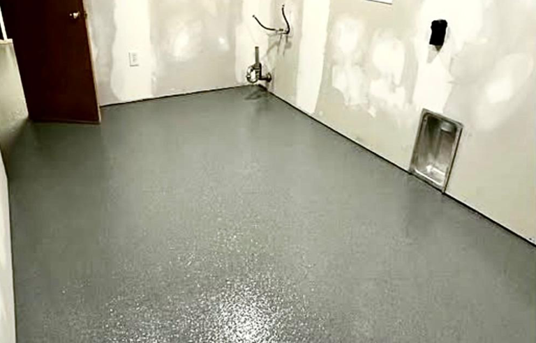 Before-and-after of basement floor: dull concrete vs. black and silver metallic epoxy