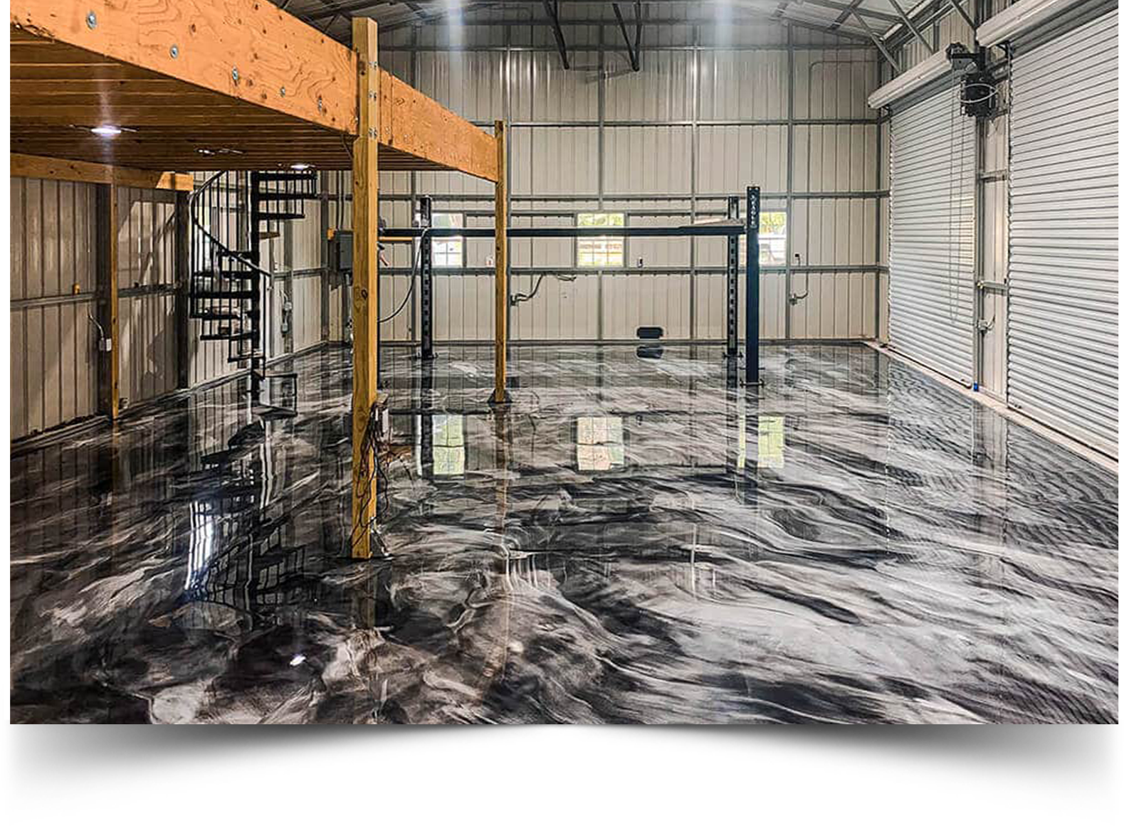 Black and white metallic epoxy floor with marbled swirl design in a garage